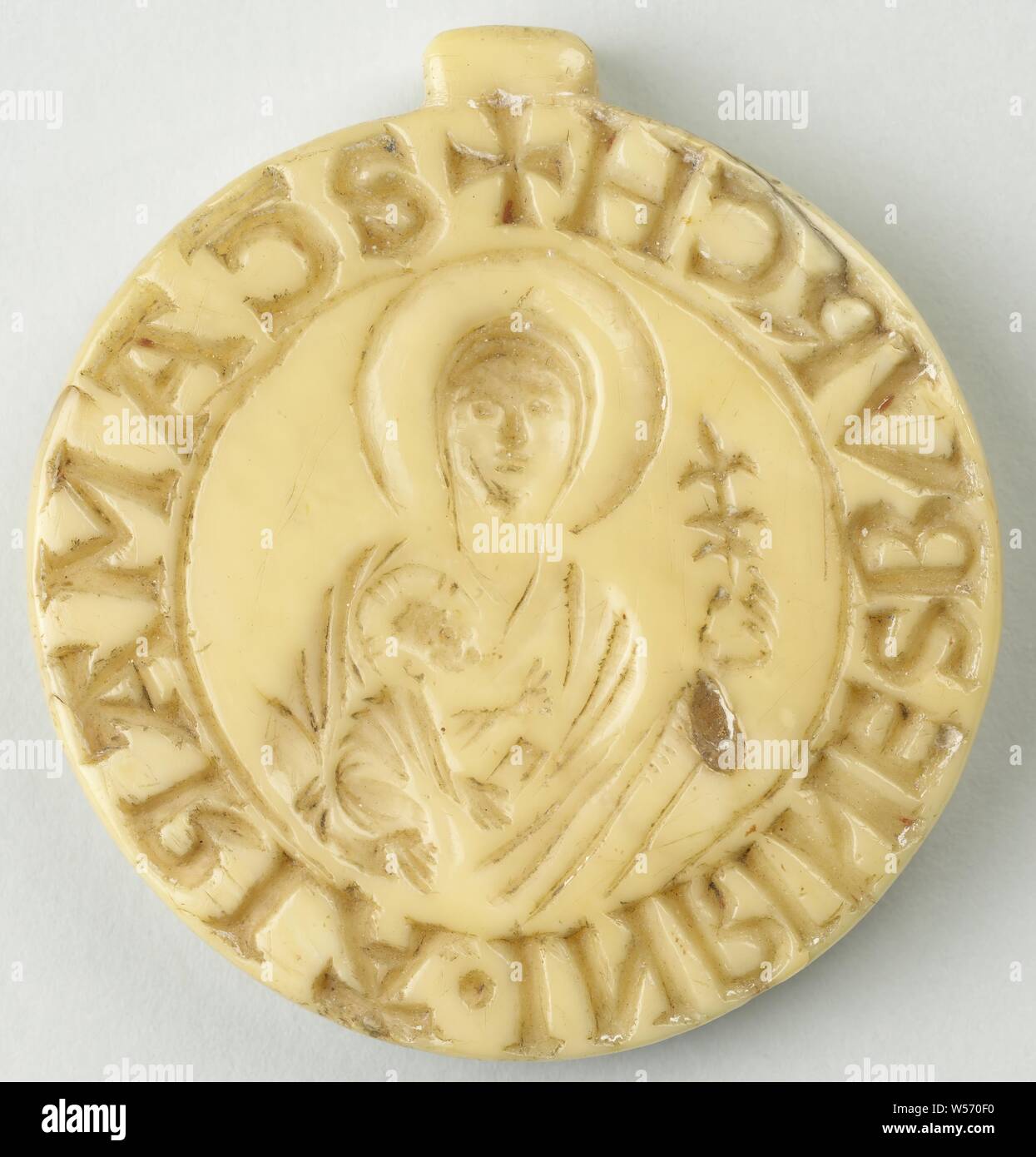 Convent seal of Rijnsburg Abbey Convents seal of the abbey of Rijnsburg, Around convents seal of the abbey of Rijnsburg. Above the cross mark in the border lettering an oblong protrusion. Depicted Mary in half body with the Christ child on her lap. Maria is shown frontally. Nimbed. Byzantine robe, the head covered by a cloth. In the left hand a twig (lily). The right hand supports the Christ child, which grasps the twig with both hands. It wears a long robe. Kruisnimbus. Inscription: SCA MARIA. IN RINESBURCH / rand, Madonna: Mary standing (or half-length), Christ-child close to her bosom Stock Photo