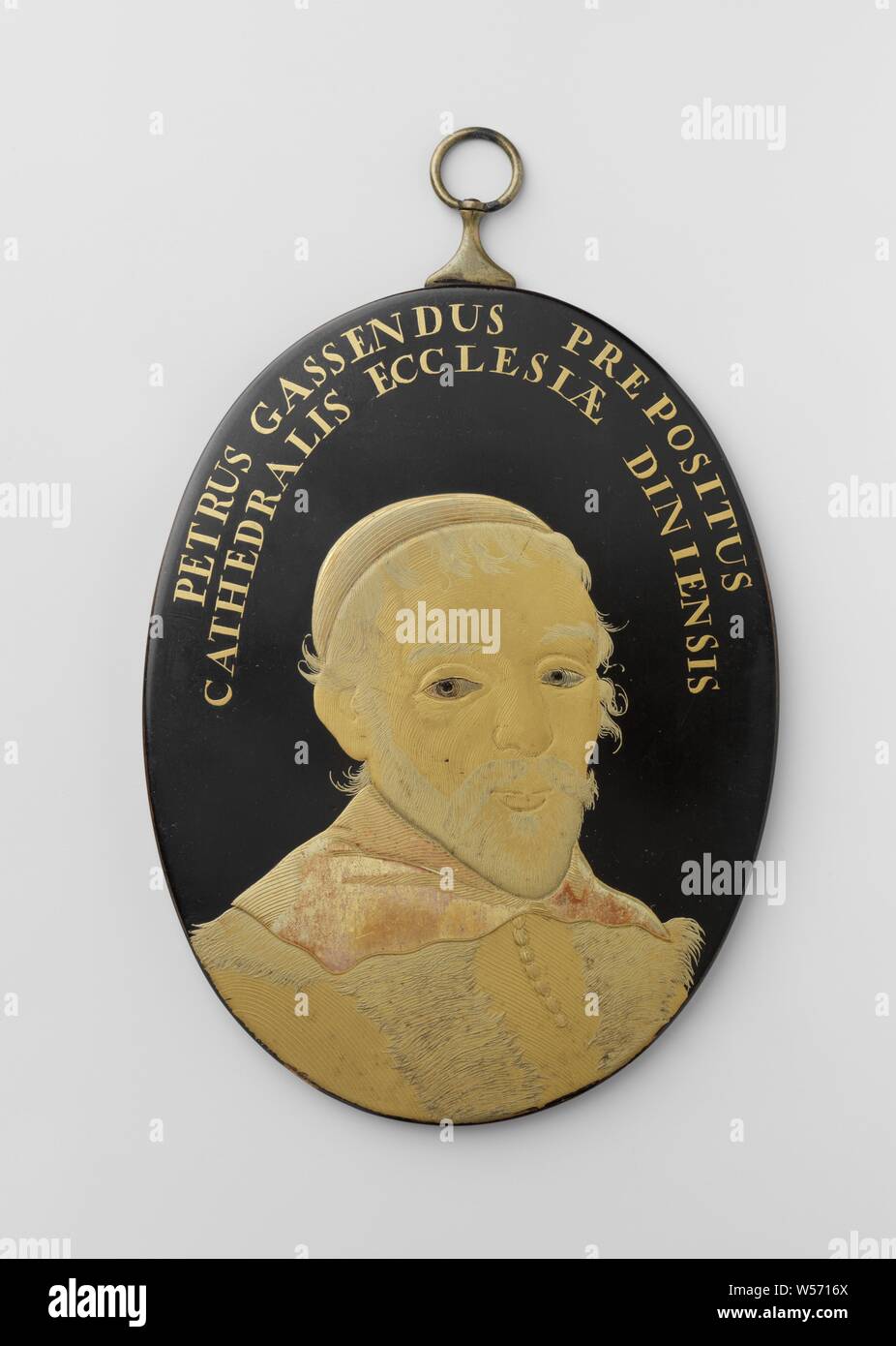 Pierre Gassendi, Petrus Gassendus (title on object), Oval plaque with the bust on the lower half facing man to the right. The man has a mustache and beard. He is wearing a high-necked cloak with fur decoration and a square collar. He has a calot on his head. Remnants of red color are visible on collar and calot. Edge lettering front: PETRUS GASSENDUS PREPOSITUS CATHEDRALIS ECCLESIAE DINIENSIS. Inscription reverse: Mellan Gatt: det et sculp., anonymous, Japan, 1775 - 1800, lacquer (coating), copper (metal), gold (metal), paint (coating), h 11.7 cm × w 8.8 cm × d 0.5 cm Stock Photo