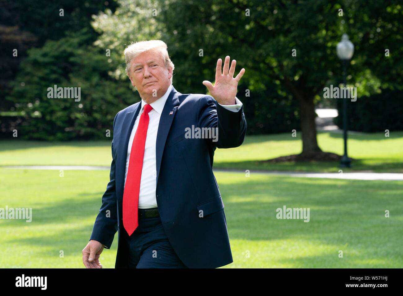 U.S President Donald Trump waves to members of the press prior to ...