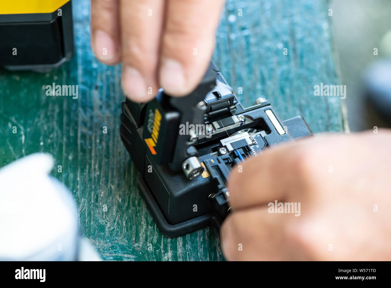 Device for mounting optical cable. Optical internet Technology concept. Optical fiber assembly. Stock Photo