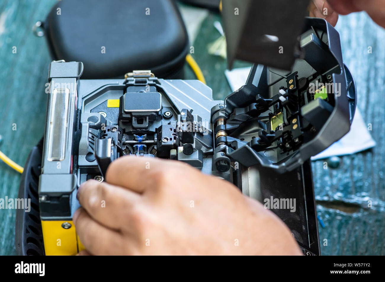 Device for mounting optical cable. Optical internet Technology concept. Optical fiber assembly. Stock Photo
