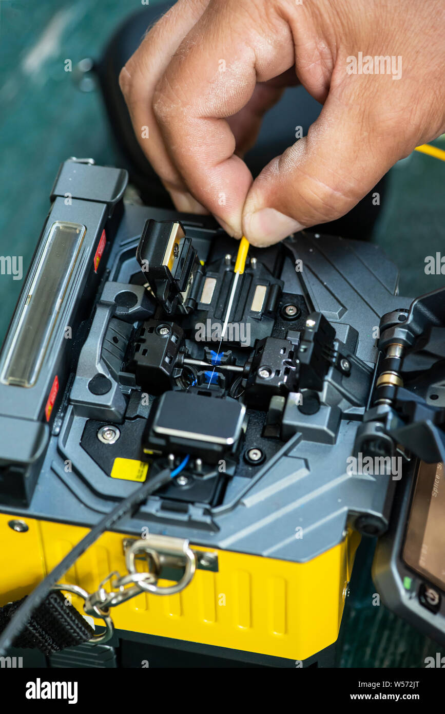 Device for mounting optical cable. Optical internet Technology concept. Optical fiber assembly. Stock Photo