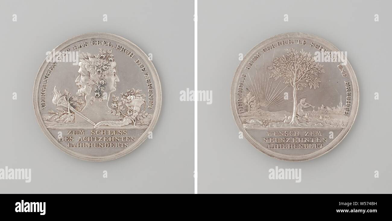 Beginning of the 19th century, Silver Medal. Obverse: hanging with flowers and leaves Janus head between burning torch decorated with cypress leaves and filled horn of abundance next to rose bush within an inscription, cut off: inscription. Reverse: man sitting under a tree, blowing on a trumpet, lit by rays of the setting sun within an inscription, cut off: inscription, Daniel Friedrich Loos (possibly), Berlin (possibly), 1799 - 1800, silver (metal), striking (metalworking), d 3.6 cm × w 13.56 Stock Photo