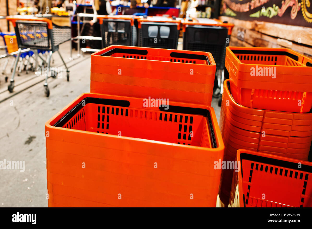 Orange plastic shopping baskets on supermarket Stock Photo Alamy