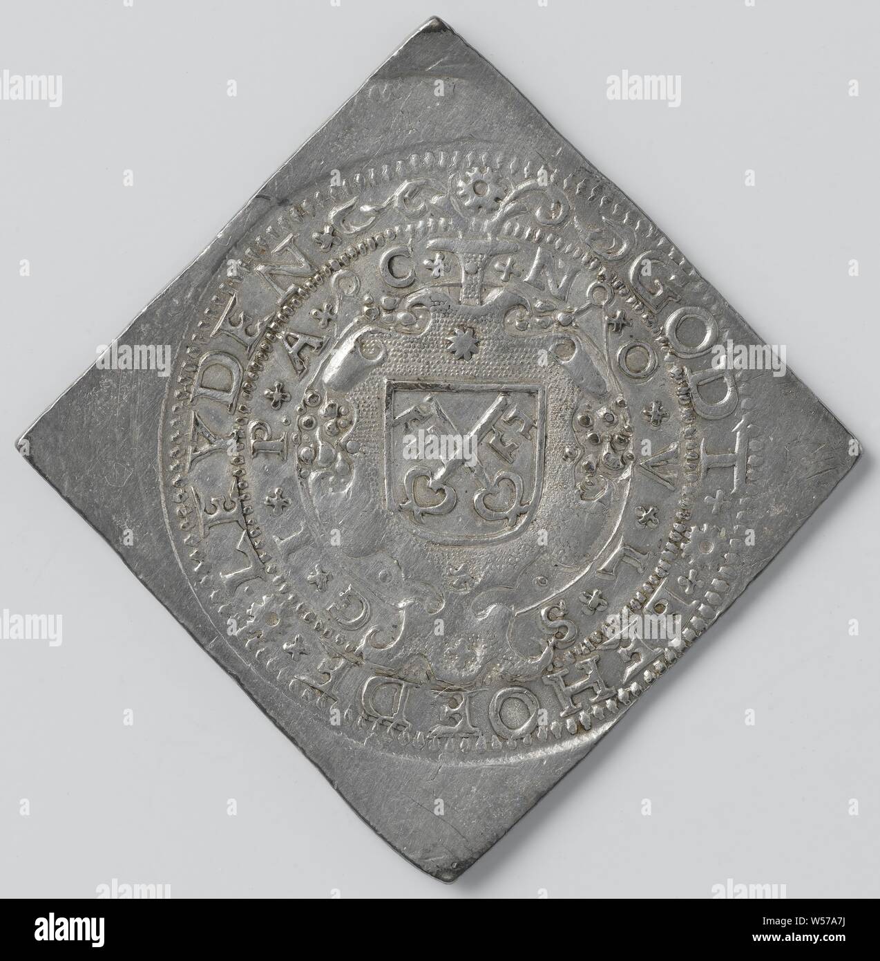 Twenty-eight pennies, siege of Leiden, emergency coin made of silver from churches and monasteries, diamond shaped emergency coin. Front: coat of arms in cartouche inside two-line circumference. Reverse: lion with freedom hat on spear in both claws between year within a circumscription, Leiden, anonymous, Dordrecht, 10-Jul-1574, silver (metal), striking (metalworking), h 5.1 cm × h 5 cm × w 19.44 Stock Photo