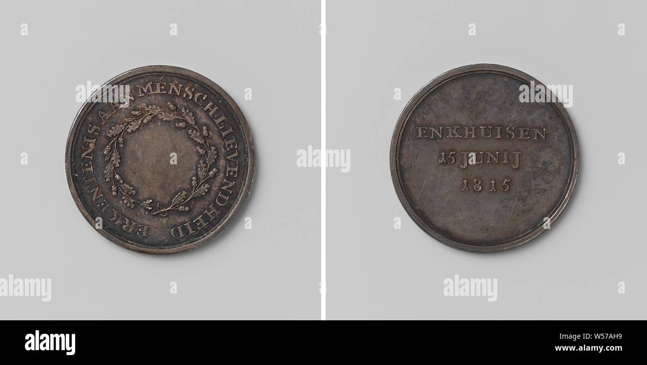 City of Enkhuizen, medal awarded for charity shown during the collapse of a bridge on the day the herring fleet sailed out, Silver medal. Front: blank field within oak wreath and circumscription. Reverse: inscription, Enkhuizen, anonymous, Netherlands, 1815, silver (metal), striking (metalworking), d 2.7 cm × w 6.47 Stock Photo