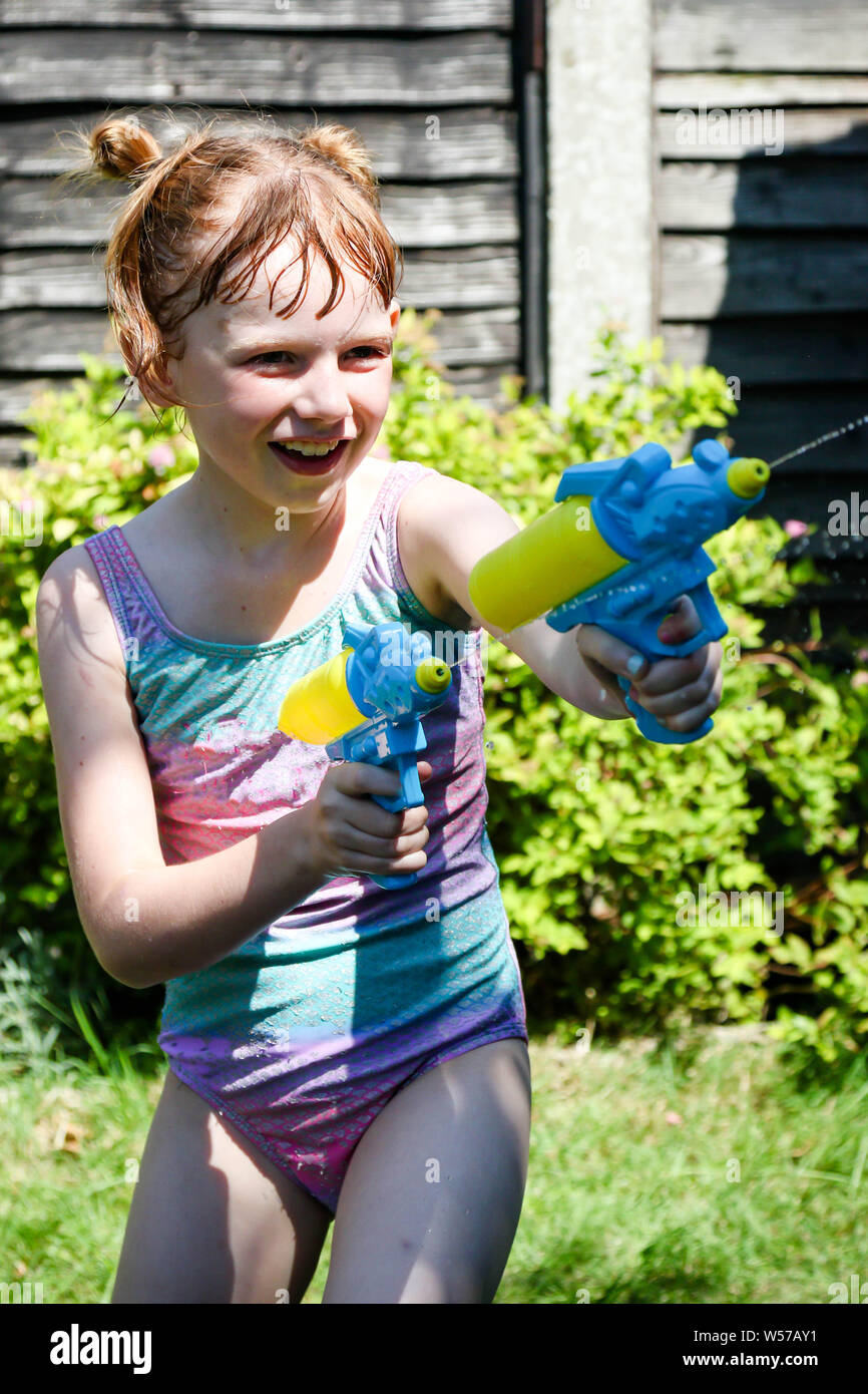 Adorable Little Girl Playing with Water Gun on Hot Summer Day. Cute Child  Having Fun with Water Outdoors Stock Photo - Image of leisure, beautiful:  97180460