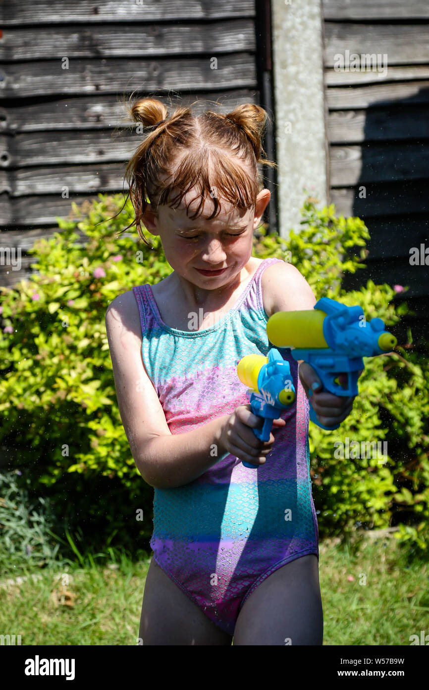 Adorable Little Girl Playing with Water Gun on Hot Summer Day. Cute Child  Having Fun with Water Outdoors Stock Photo - Image of leisure, beautiful:  97180460