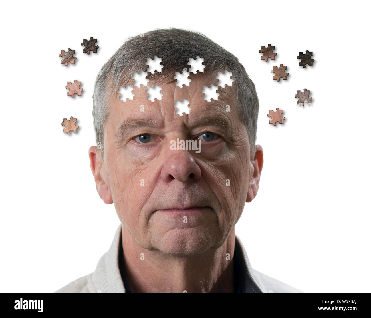 Jigsaw concept of mental illness or dementia with senior caucasian man looking sad into camera Stock Photo