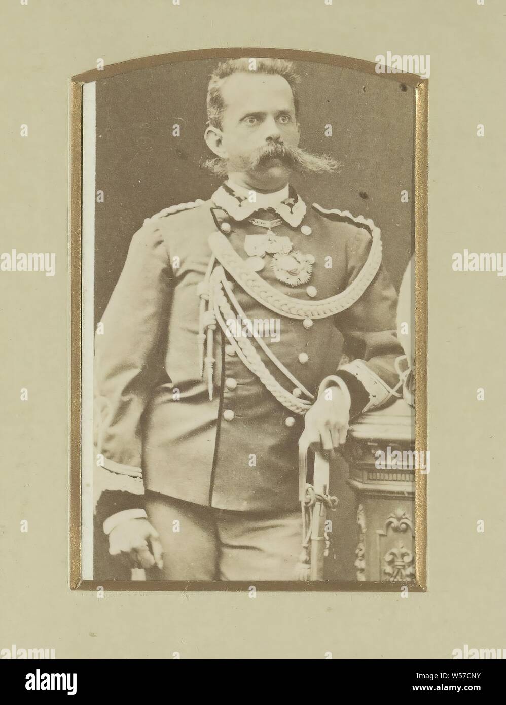 Portrait of a (probably) Italian soldier, standing with saber in his hand, Part of Album with cartes-de-visite and cabinet photos of soldiers in uniform., warfare, military affairs, division of armed forces, (military) uniforms, mustache, hacking and thrusting weapons (with NAME), Italy, anonymous, Italy (possibly), c. 1860 - c. 1880, cardboard, paper, photographic paper, albumen print, h 104 mm × w 61 mm Stock Photo
