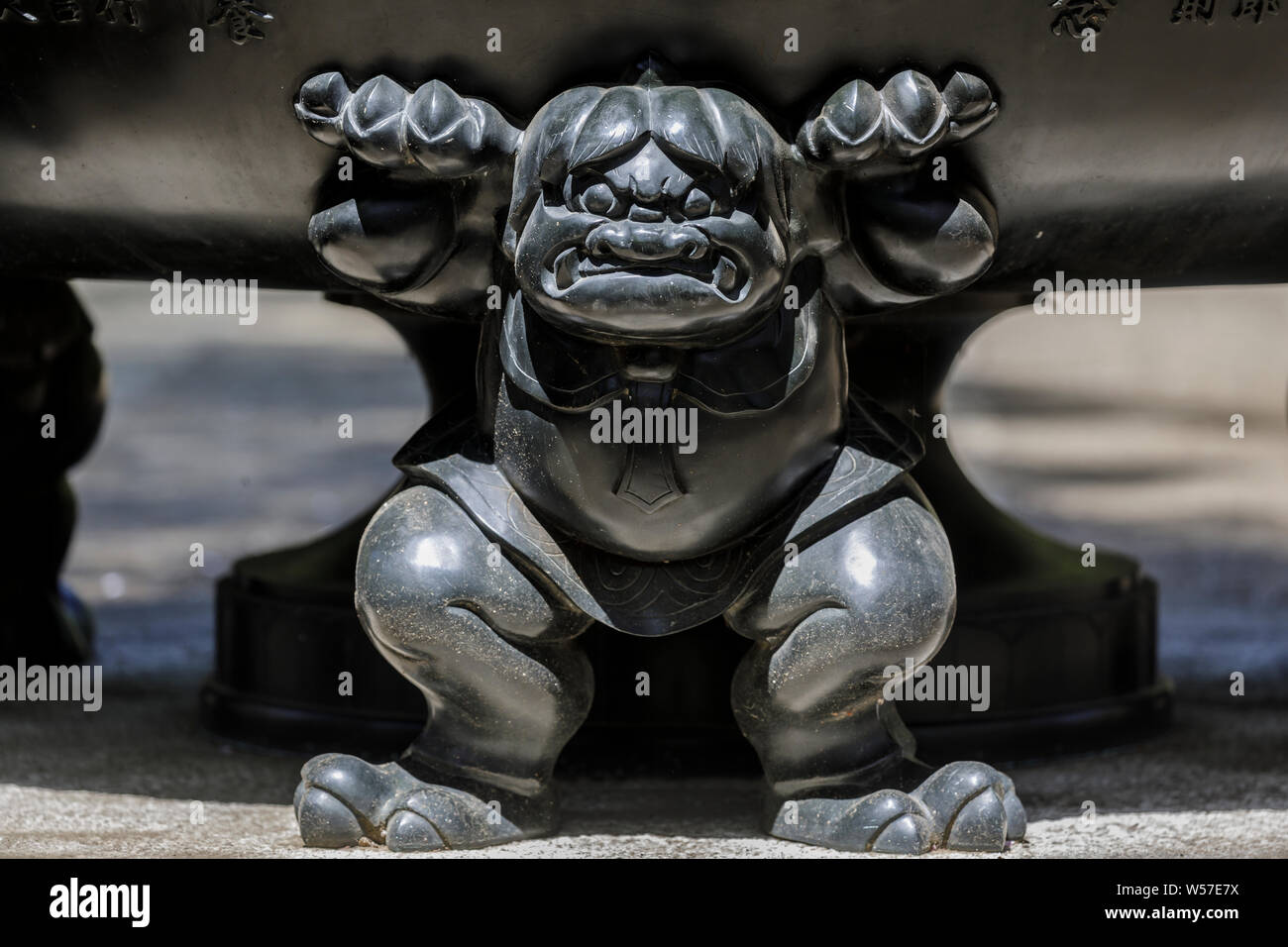 Carved figure on a giant urn at Gotokuji Temple in Setagaya city, Tokyo, Japan. Stock Photo