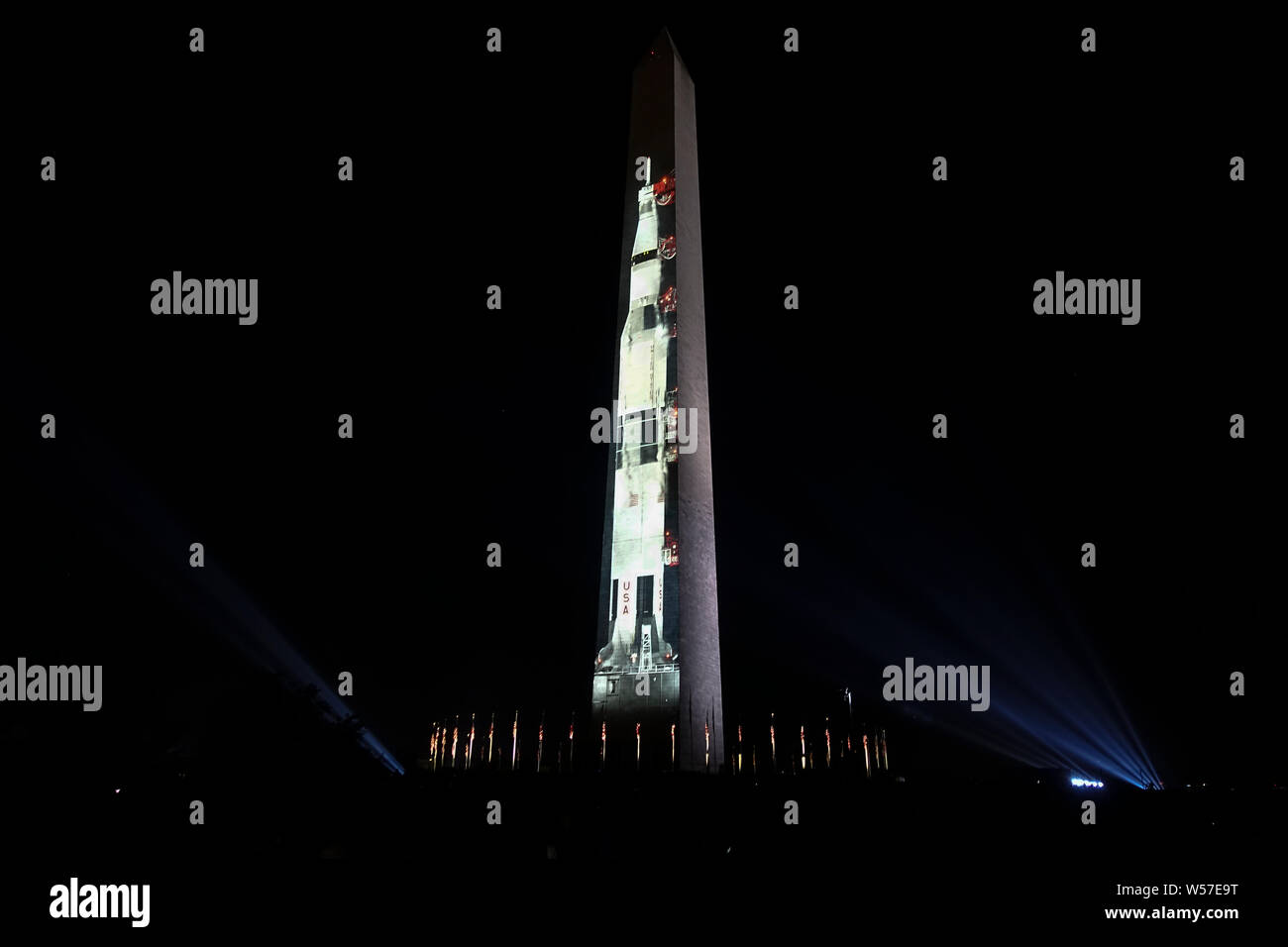 Washington, DC - July 18, 2019. Celebrating the 50th anniversary of the first lunar landing, an image of the Saturn V rocket at its launch pad is projected onto the Washington Monument, part of a five-day commemorating the Apollo 11 moon landing in 1969. Stock Photo