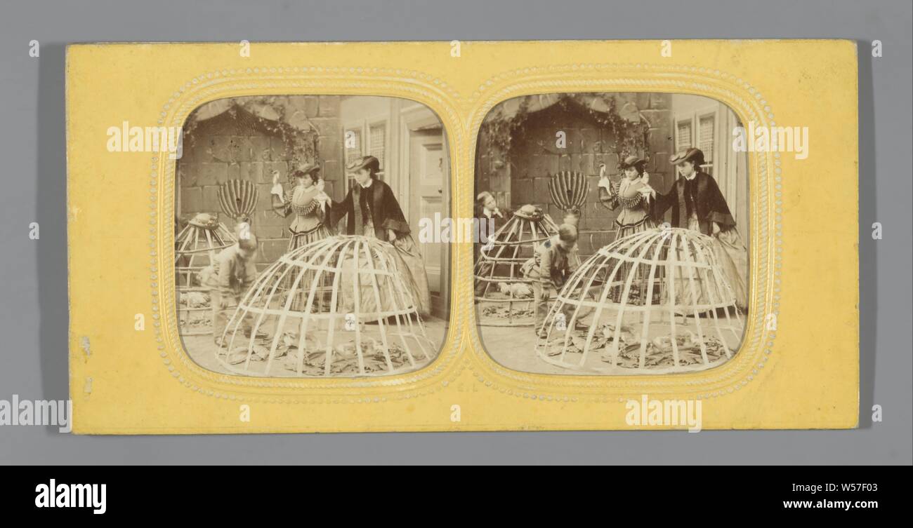 Outdoor table: two boys with crinoline skirts converted into bird cages, two angry women in the background, EL, 1865 Stock Photo