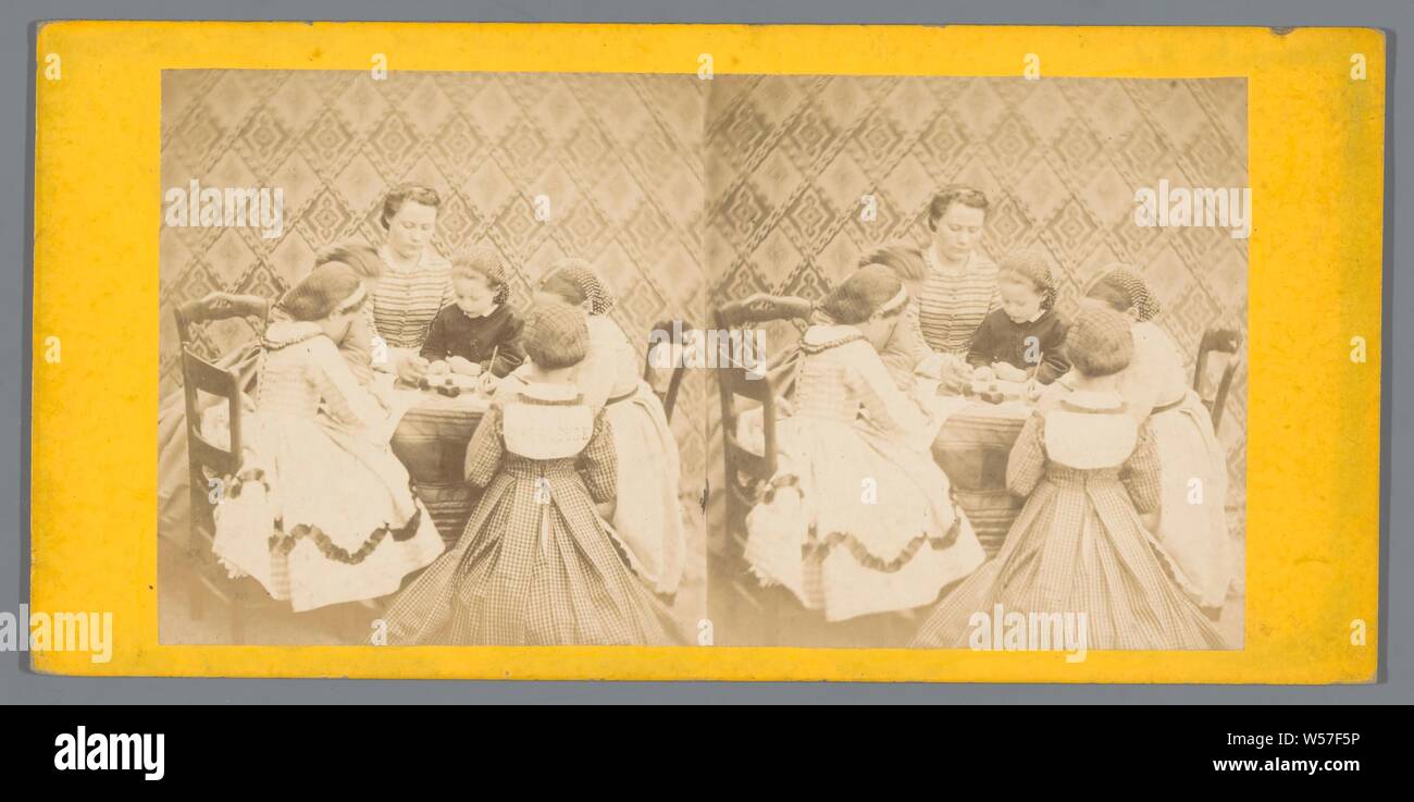 Woman with children playing around a table, sitting figure, children's games and plays, Europe, anonymous, c. 1850 - c. 1880, cardboard, photographic paper, albumen print, h 85 mm × w 170 mm Stock Photo