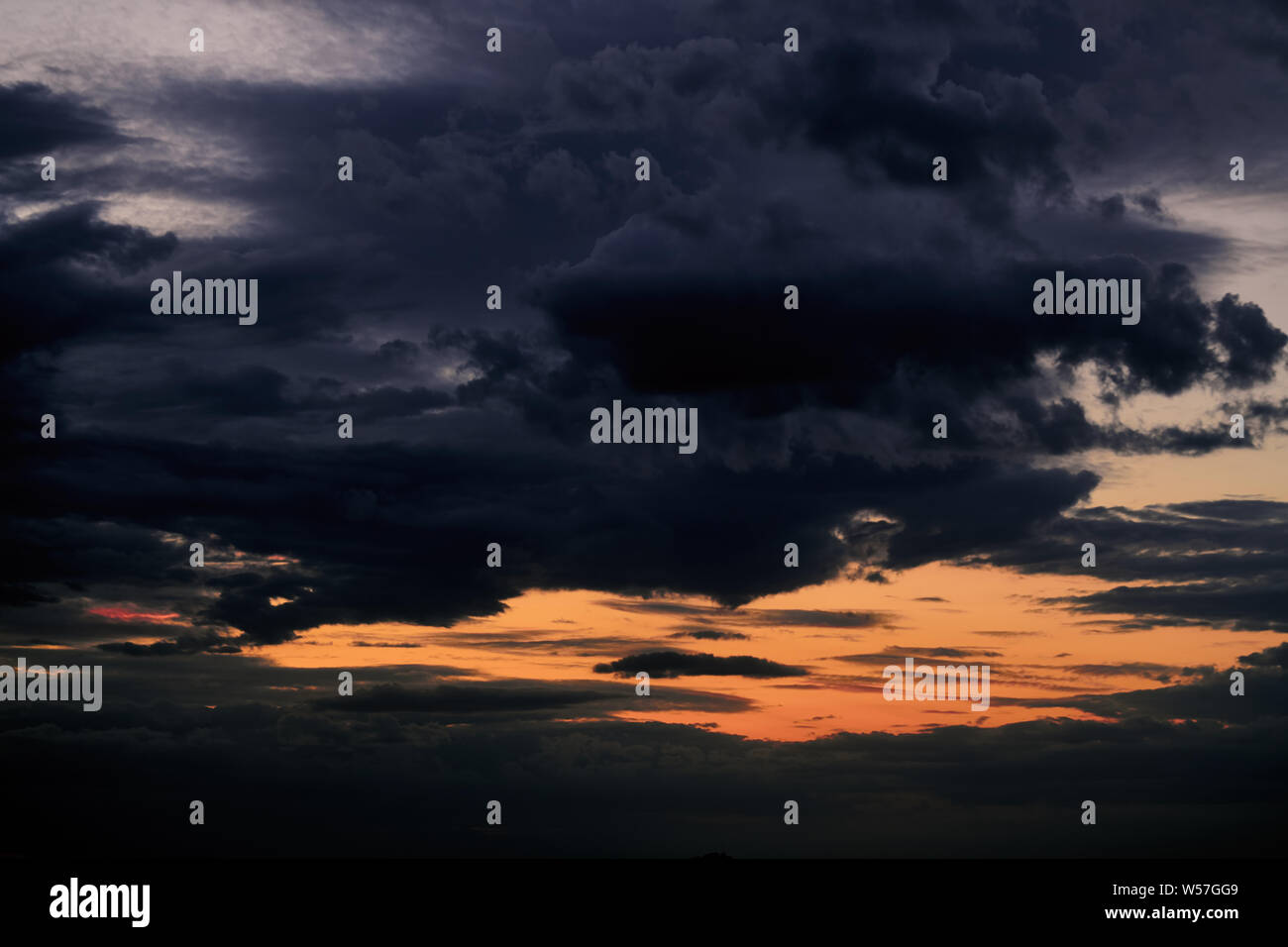 Beautiful sunset - dark sky with clouds and sunlight Stock Photo - Alamy