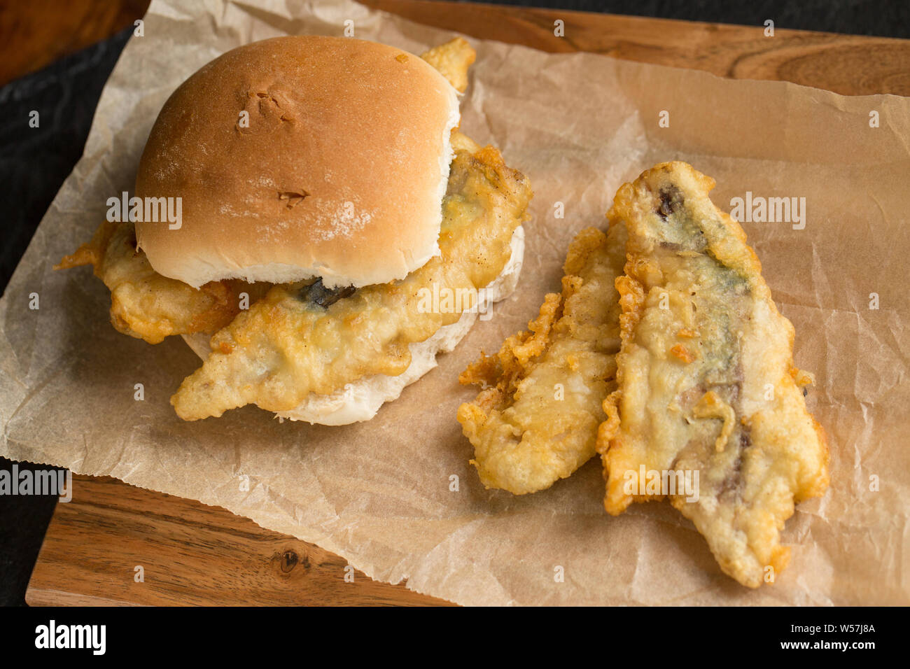 Fillets of mackerel, Scomber scombrus, that have been dipped in flour and batter and deep fried to make a homemade mackerel burger. The mackerel were Stock Photo