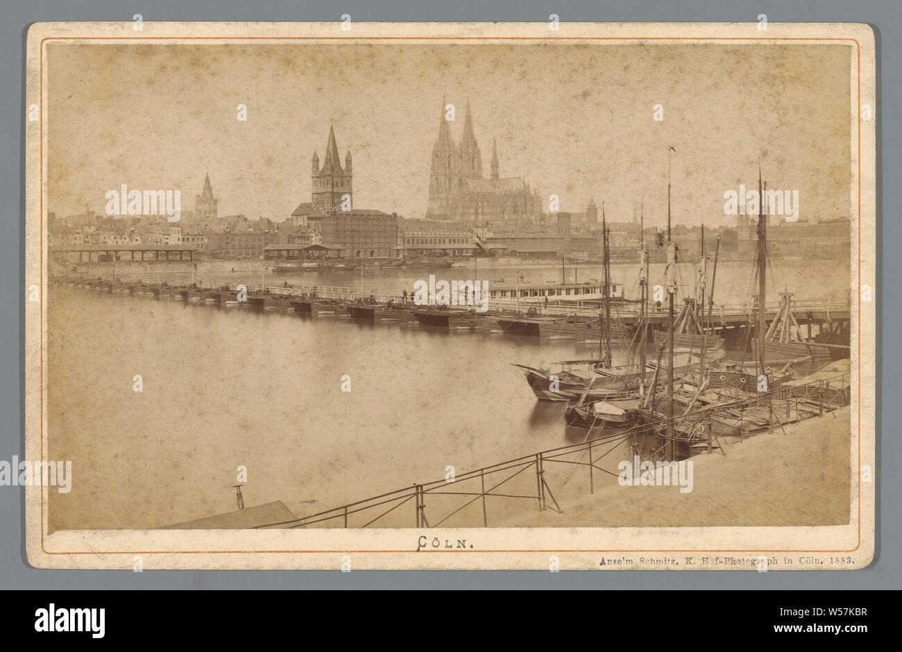View of Cologne Cöln (title on object), city view, and landscape with man-made constructions, bridge, Cologne, A. Schmitz (Anselm) (mentioned on object), Keulen, 1883, cardboard, photographic paper, albumen print, h 108 mm × w 168 mm Stock Photo