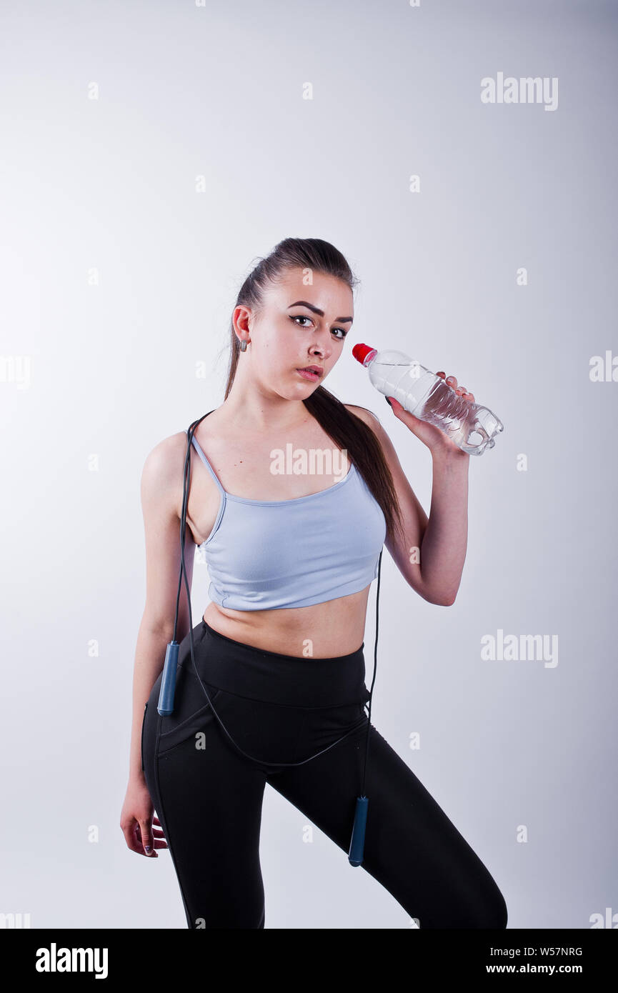 Cheerful attractive young fitness woman in top and black leggings with ...