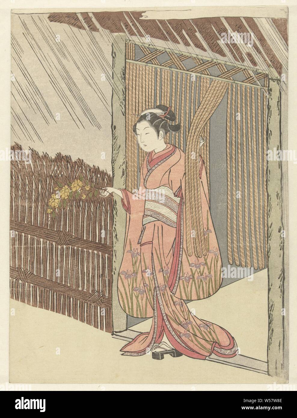 Girl with a yamabuki branch in hands, Girl in pink kimono with iris pattern and in her right hand a branch with yellow flowers, standing in doorway., Suzuki Harunobu, Japan, 1764 - 1768, paper, colour woodcut, h 277 mm × w 207 mm Stock Photo