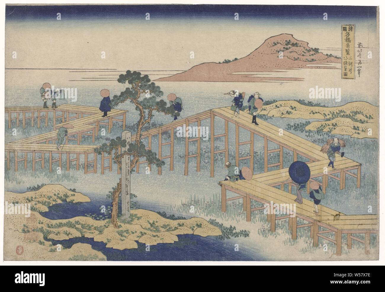 The zigzag bridge in the province of Mikawa Mikawa no yatsuhashi no kozu (title on object) Views of famous bridges in the provinces (series title) Shokoku meikyo kiran (title on object), Travelers on the famous zigzagging bridge, looking at the flowering irises in the swamp. In the foreground a pine tree near a Buddhist monument, landscape with bridge, viaduct or aqueduct, Katsushika Hokusai (mentioned on object), 1830 - 1834, paper, colour woodcut, h 262 mm × w 384 mm Stock Photo