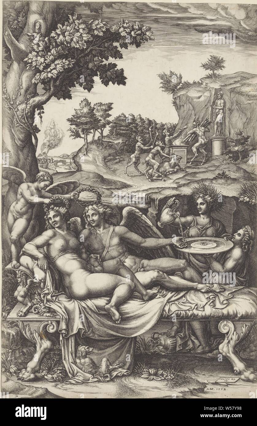 Amor and Psyche, Amor and Psyche lie with their child (Voluptas) on a chaise longue in a landscape. A winged figure holds laurel wreaths above the heads of Amor and Psyche. On the right Ceres pours water on Amor's hand. His hand is leaning on a scale carried by Juno. In the background a group of satyrs offering a goat for a statue of the gods. In the foreground lies a dog., Cupid and Psyche as lovers, Giorgio Ghisi (mentioned on object), 1574, paper, engraving, h 357 mm × w 230 mm Stock Photo