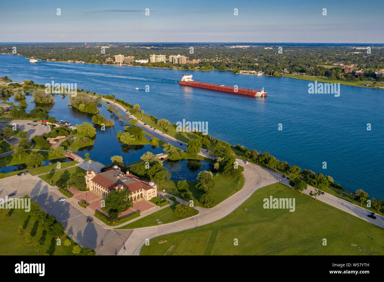 Detroit, Michigan - A bulk cargo carrier in the Detroit River passes Belle Isle State Park. Stock Photo