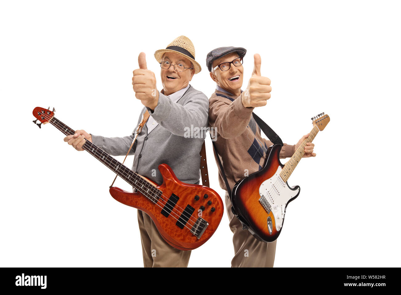 Two elderly men with electric guitars showing thumbs up isolated on white background Stock Photo