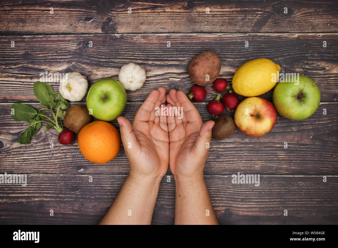 Man hold opened hands and fruits and vegetables around them Stock Photo ...