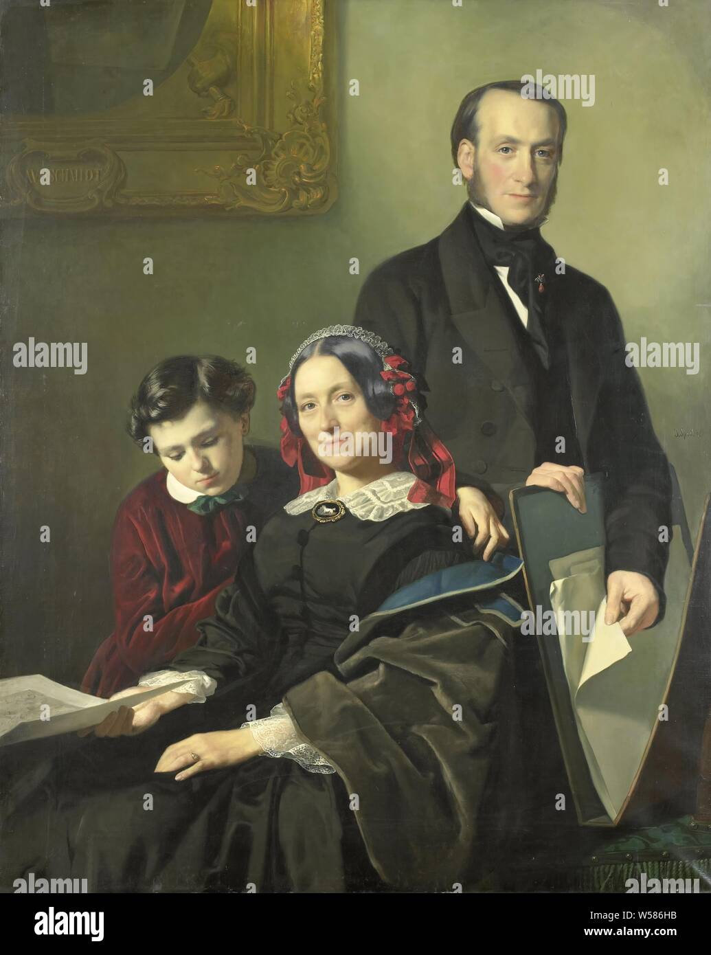 Mrs A J Schmidt-Keiser, widow of the painter Willem Hendrik Schmidt (1809-49), the teacher of Jacob Spoel, with her brother J N Keiser and her ten-year-old son, Portrait of Mrs A.J. Schmidt-Keiser, with her brother J.N. Keiser and her ten-year-old son. The woman is holding a drawing in his right hand, the man is browsing through a portfolio of drawings. On the wall an allegorical painting by W.H. Schmidt with a torch that is put out., Jacob Spoel, 1858, canvas, oil paint (paint), h 143.5 cm × w 115 cm d 5.3 cm Stock Photo