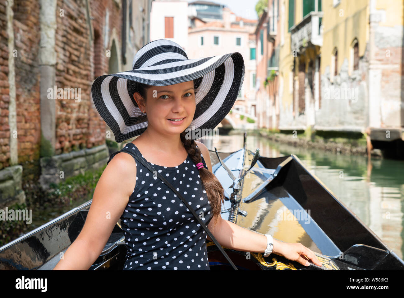 Portrait Of A Happy Young Woman Wearing Hat Enjoying The Ride In Gondola Stock Photo