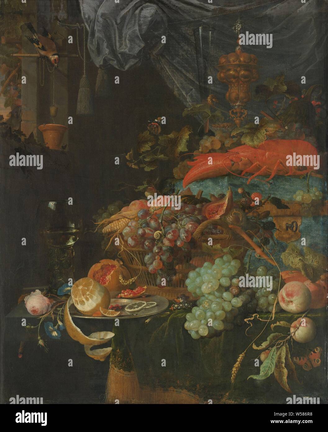 Still Life with Fruit and a Goldfinch, Still life with fruits and a putter. At the front left a plate with a lemon next to a rummer with white wine. In the middle a large basket with bunches of white and blue grapes, chestnuts, berries, corn and peaches. In the background a lobster, a decorative bowl and a tall glass. To the left of the window, a putter collects a bowl of water. Among the fruits through vines with here and there butterflies., Abraham Mignon, 1660 - 1679, canvas, oil paint (paint), h 78 cm × w 67 cm Stock Photo