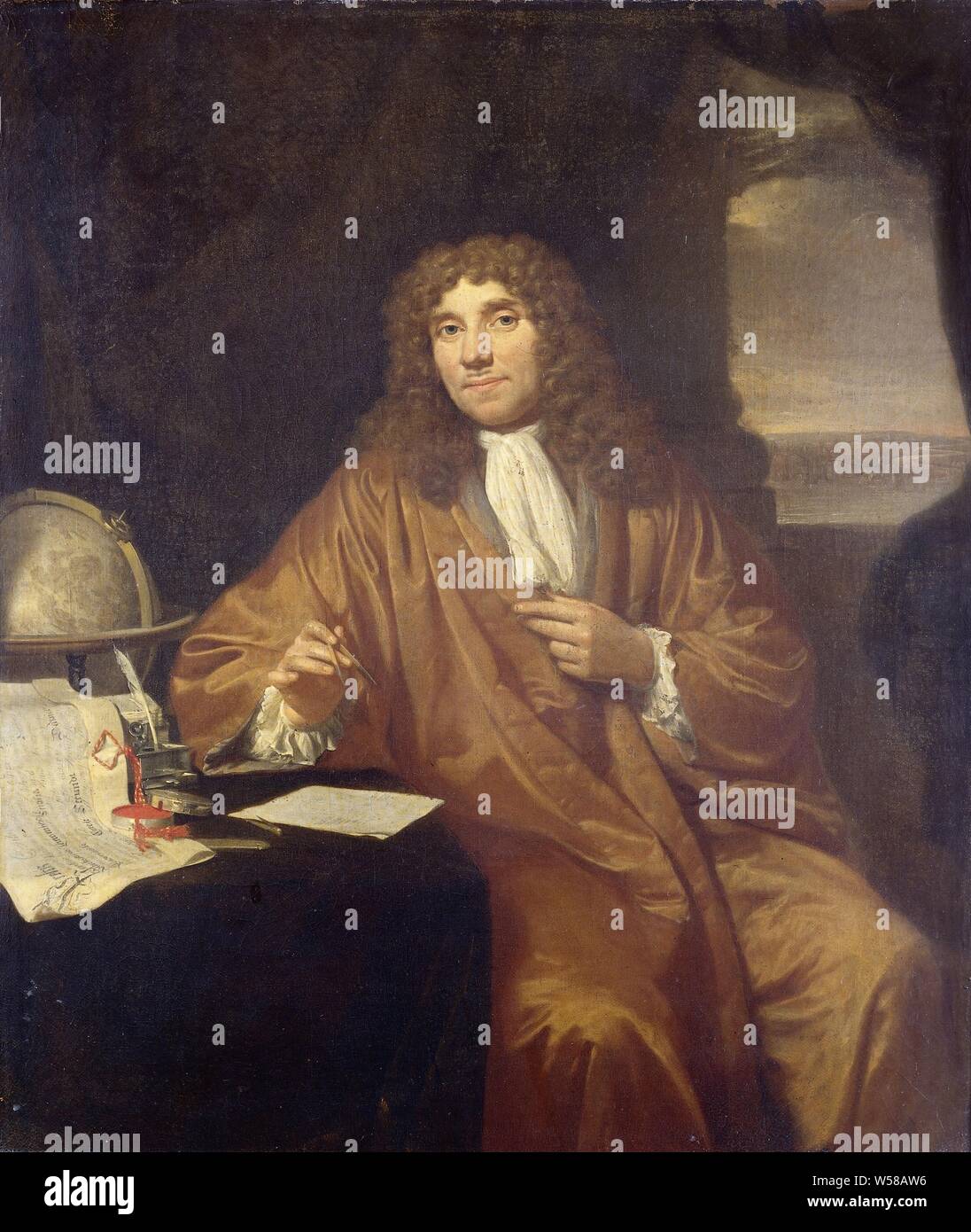 Portrait of Anthonie van Leeuwenhoek, Natural Philosopher and Zoologist in Delft, Portrait of Anthonie van Leeuwenhoek (1632-1723), physicist in Delft. Knee-piece sitting at a writing table with a certificate of his appointment as a member of the Royal Society in London by Charles II. Furthermore, a globe and an ink set, he holds a compass, Delft, Anthony van Leeuwenhoek, Jan Verkolje (I), 1680 - 1686, canvas, oil paint (paint), h 56 cm × w 47.5 cm Stock Photo