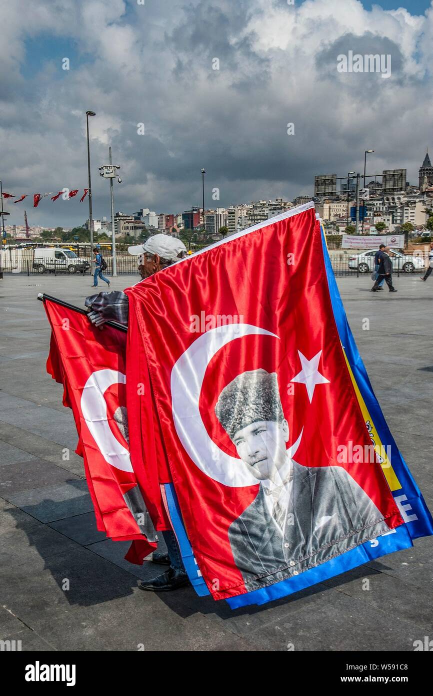 ISTANBUL, TURKEY, ambulant vendor of Turkish flags with portrait of Ataturk, founder of the modern Turkey near Galata bridge Stock Photo
