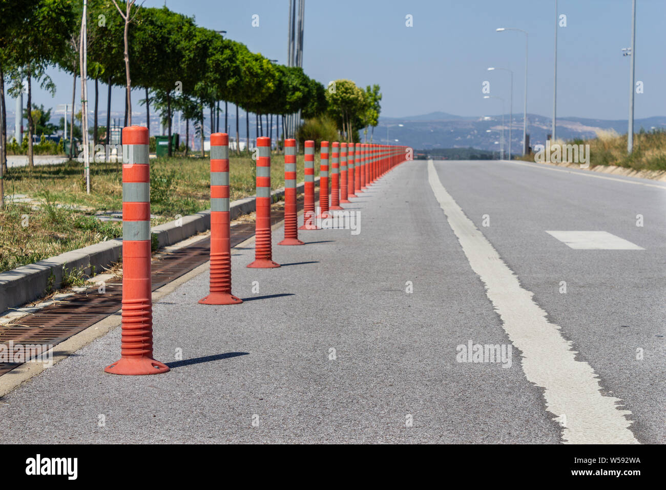 Parking barrier for traffic safety. No car parking. Red plastic fencing