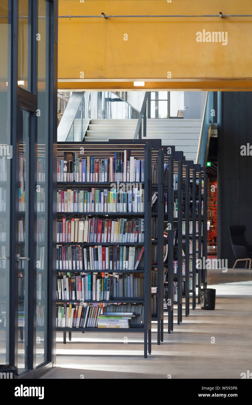 Bookshelves with massive orange steel beam overhead. Bibliotheek LocHal ...