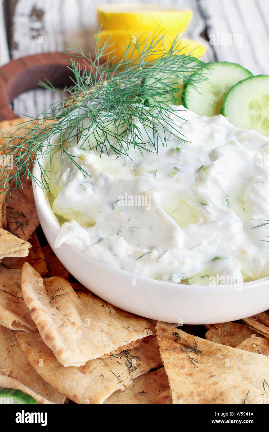 Traditional Greek Tzatziki dip sauce made with cucumber sour cream, Greek  yogurt, lemon juice, olive oil and a fresh sprig of dill weed. Served with  t Stock Photo - Alamy
