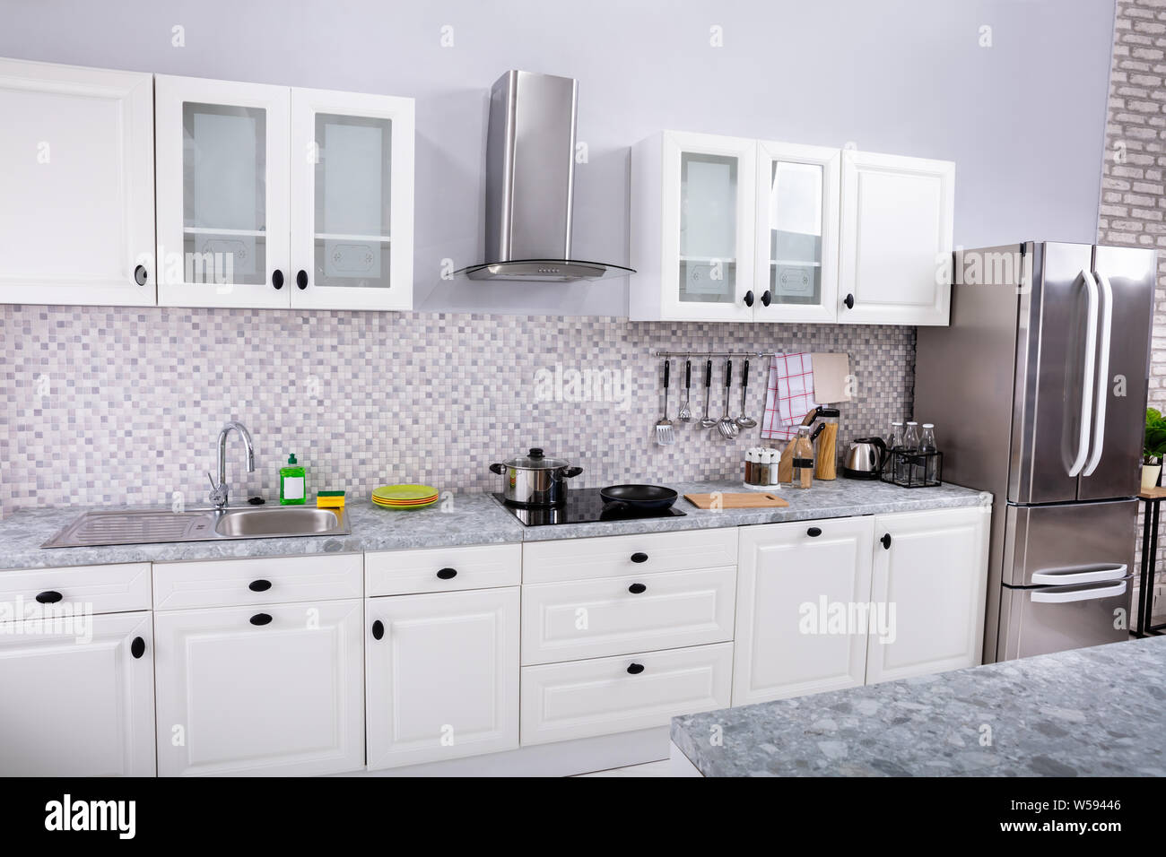 Interior Of Modern White Clean Kitchen With Microwave Oven And Refrigerator Stock Photo