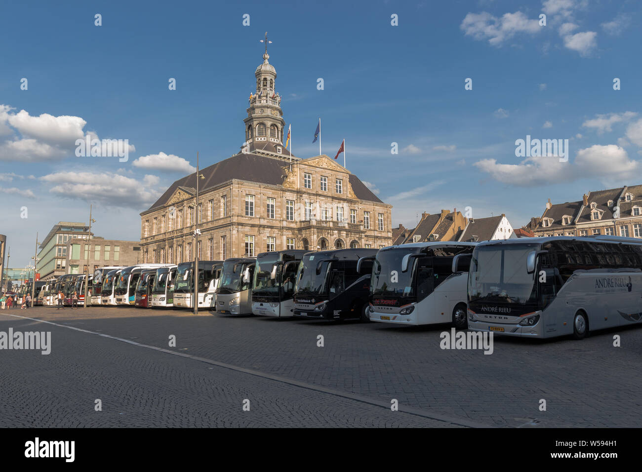 Touring cars parked on the Market square in downtown Maastricht, bringing  fans form all over the world to the concert of violin player Andre Rieu  Stock Photo - Alamy