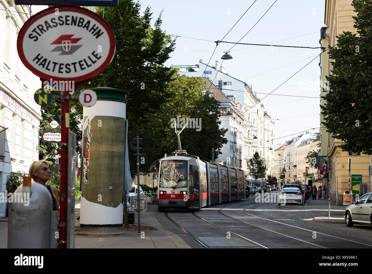 A tram arrives at a stop on Porzellangasse in the Alsergrund neighborhood of Vienna, Austria. Stock Photo