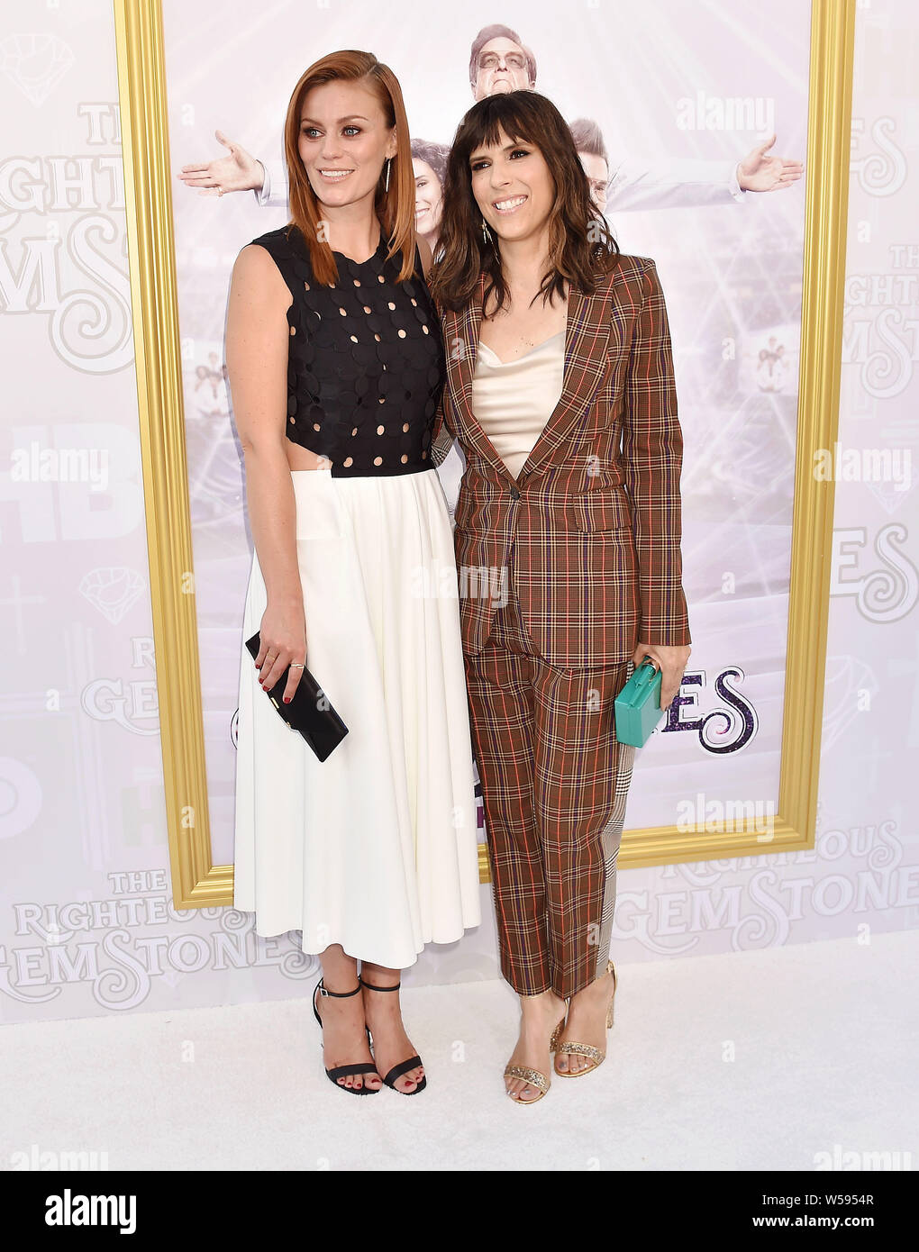HOLLYWOOD, CA - JULY 25: Cassidy Freeman (L) and Edi Patterson attend the Los Angeles Premiere Of New HBO Series 'The Righteous Gemstones' at Paramount Studios on July 25, 2019 in Hollywood, California. Stock Photo