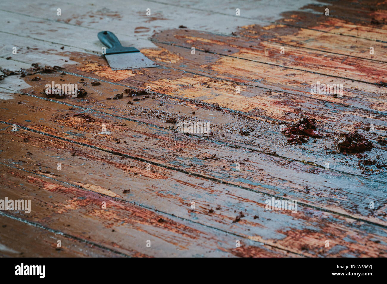 Old Wooden Floor And Scraper Tool With Paint Scraped Wooden