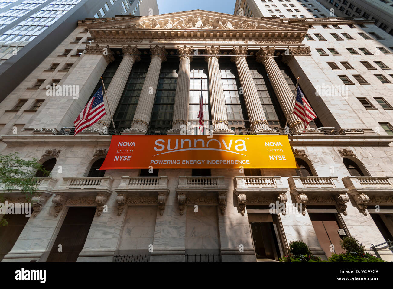 The New York Stock Exchange in Lower Manhattan in New York on Thursday, July 25, 2019 is decorated with a banner for the Sunnova initial public offering. Sunnova Energy International is a provider of solar energy systems and services for residences.  (© Richard B. Levine) Stock Photo