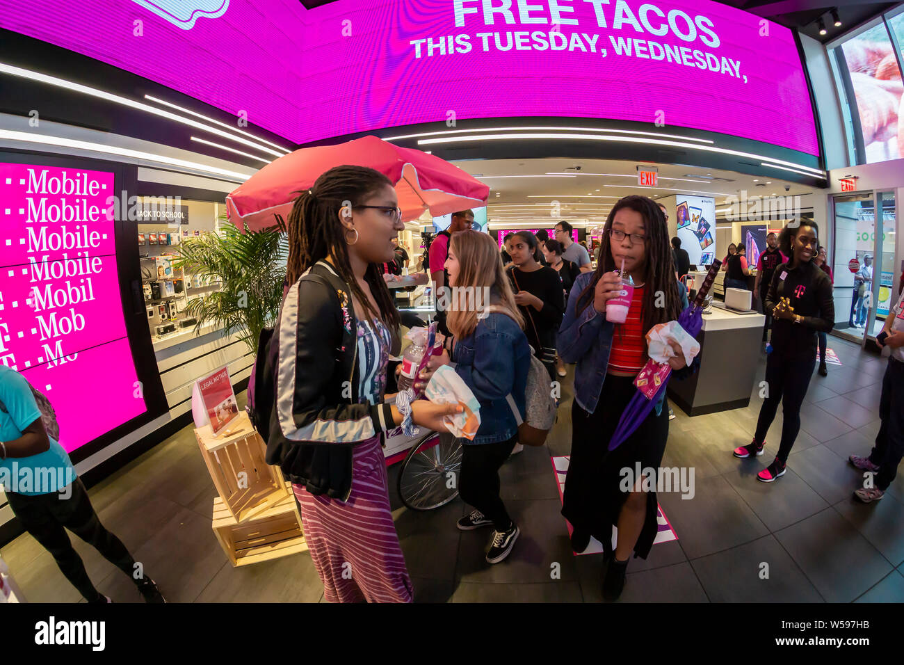 Hundreds of taco lovers descend on the T-Mobile store in Times Square in New York on Taco Tuesday, July 23, 2019 for TacoBell tacos, T-MoBell Freeze slushies and assorted free swag. The collaboration with Taco Bell rebranded the stores as ÒT-MoBellÓ. The crossover event takes over the store for three days bringing in the mobile phone loving, taco eating demographic. (© Richard B. Levine) Stock Photo