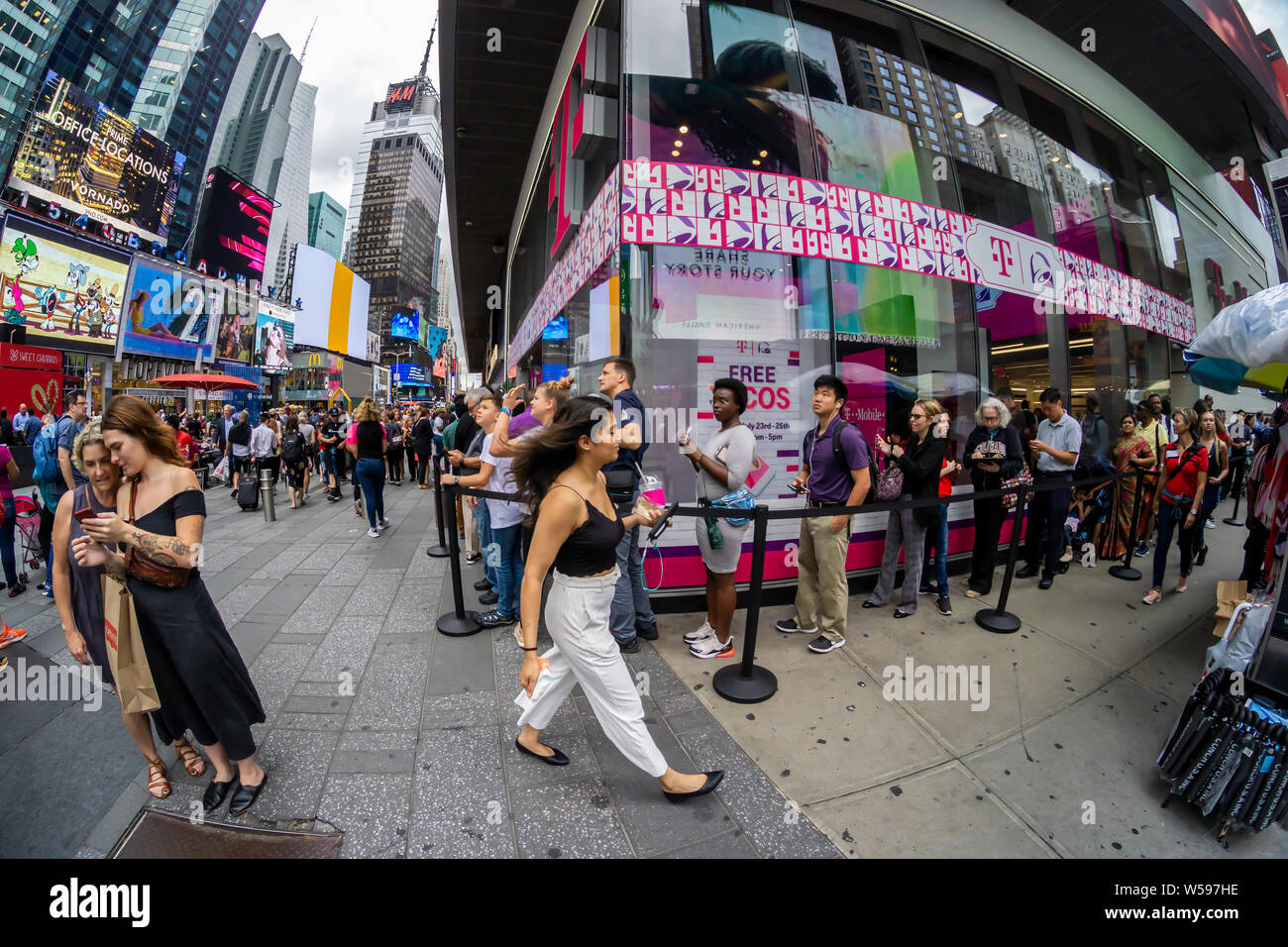 Hundreds of taco lovers descend on the T-Mobile store in Times Square in New York on Taco Tuesday, July 23, 2019 for TacoBell tacos, T-MoBell Freeze slushies and assorted free swag. The collaboration with Taco Bell rebranded the stores as ÒT-MoBellÓ. The crossover event takes over the store for three days bringing in the mobile phone loving, taco eating demographic. (© Richard B. Levine) Stock Photo