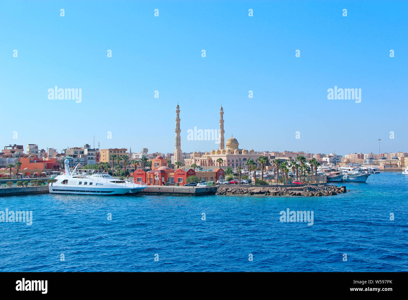View of embankment of Hurghada with moored yachts, ships and beautiful mosque. Modern Egyptian city. Seafront Hurghada. View of Egyptian city of Hurgh Stock Photo