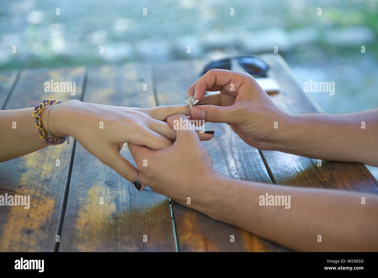 Young woman caught because her boyfriend gives an engagement ring at breakfast . The man is