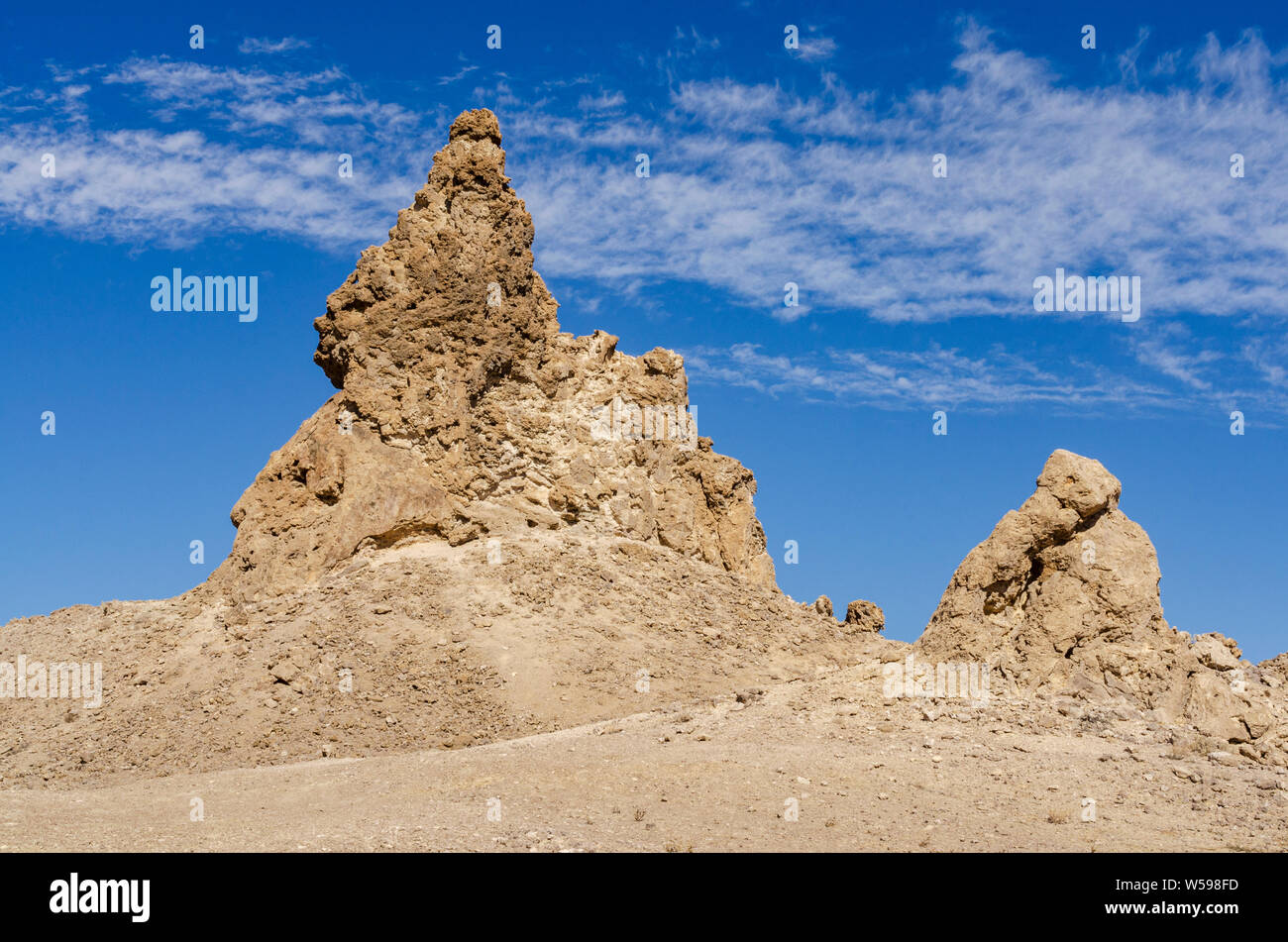 Large and small rock formations next to each other under blue skies Stock Photo