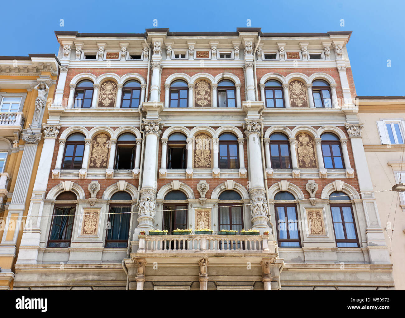 TRIESTE, Italy - June 16, 2019: Richly decorated exterior facade of an elegant historic building in Carducci street Stock Photo