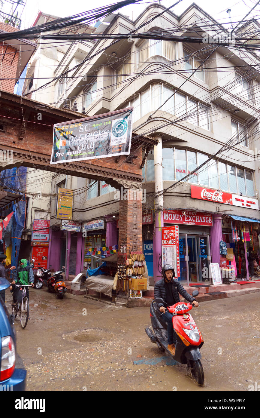 Nepalese man riding a scooter on a street of Thamel, Kathmandu Stock