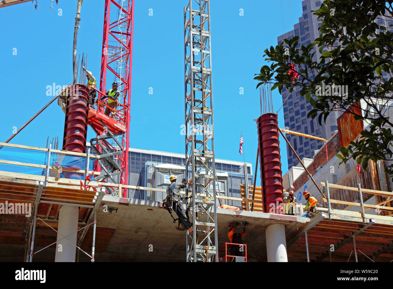 Construction workers pouring cement. Stock Photo